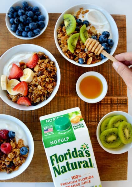 A top-down view of granola parfaits with fruit and yogurt
