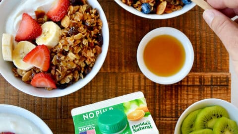 A top-down view of granola parfaits with fruit and yogurt