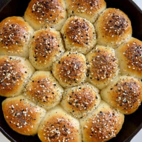 Top-down view of Everything Bagel Pull-Apart Bread with Cream Cheese in cast iron skillet