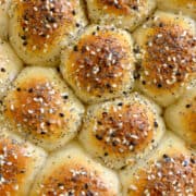 Closeup view of bagel pull-apart bread topped with everything seasoning with title underneath