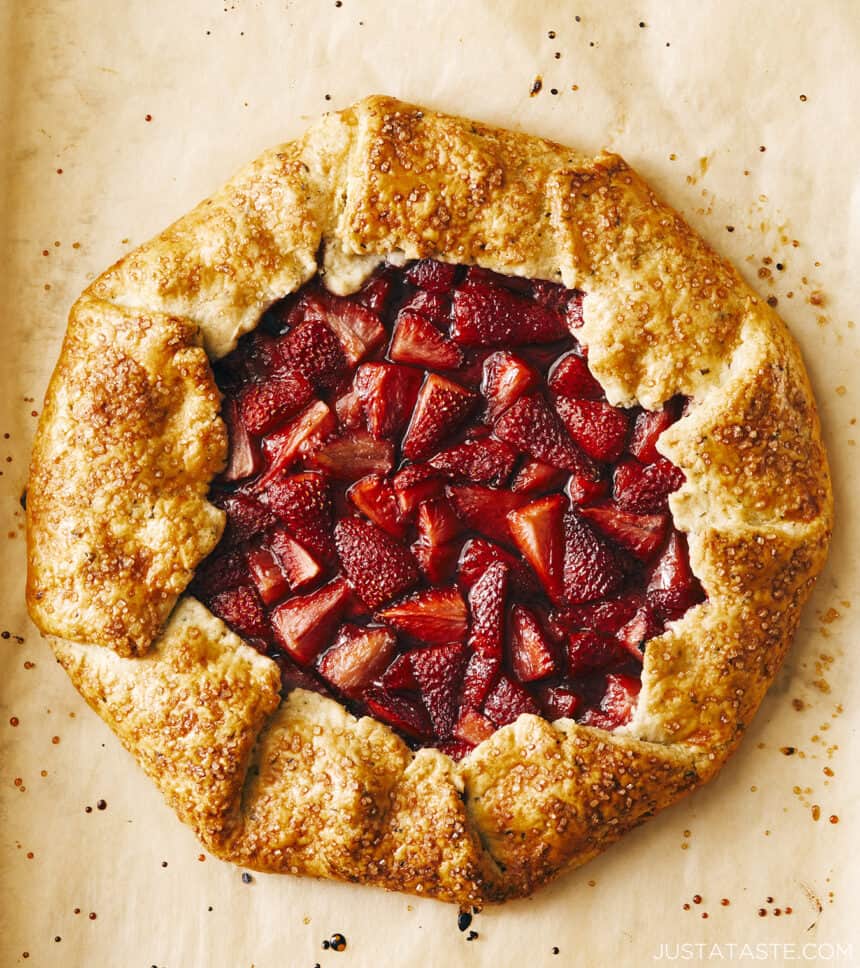 A top-down view of a Strawberry Galette on top of brown parchment paper.