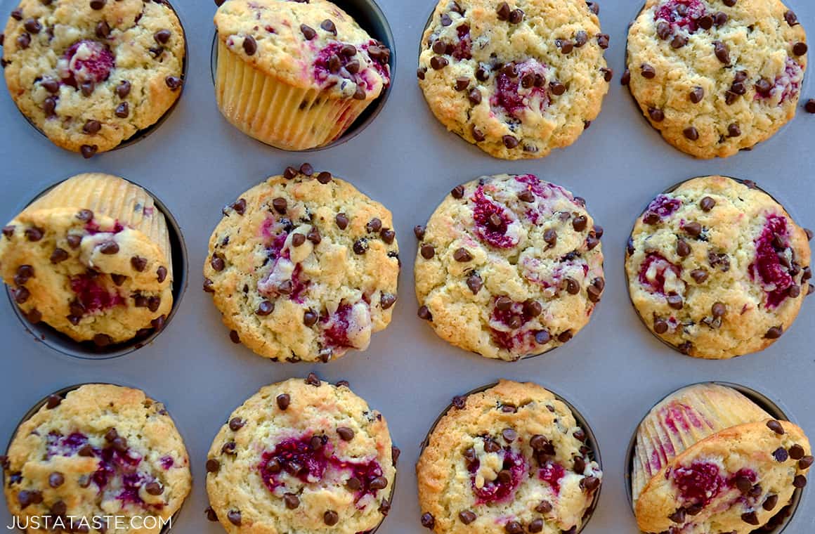 Muffins in a baking pan with raspberries and chocolate chips