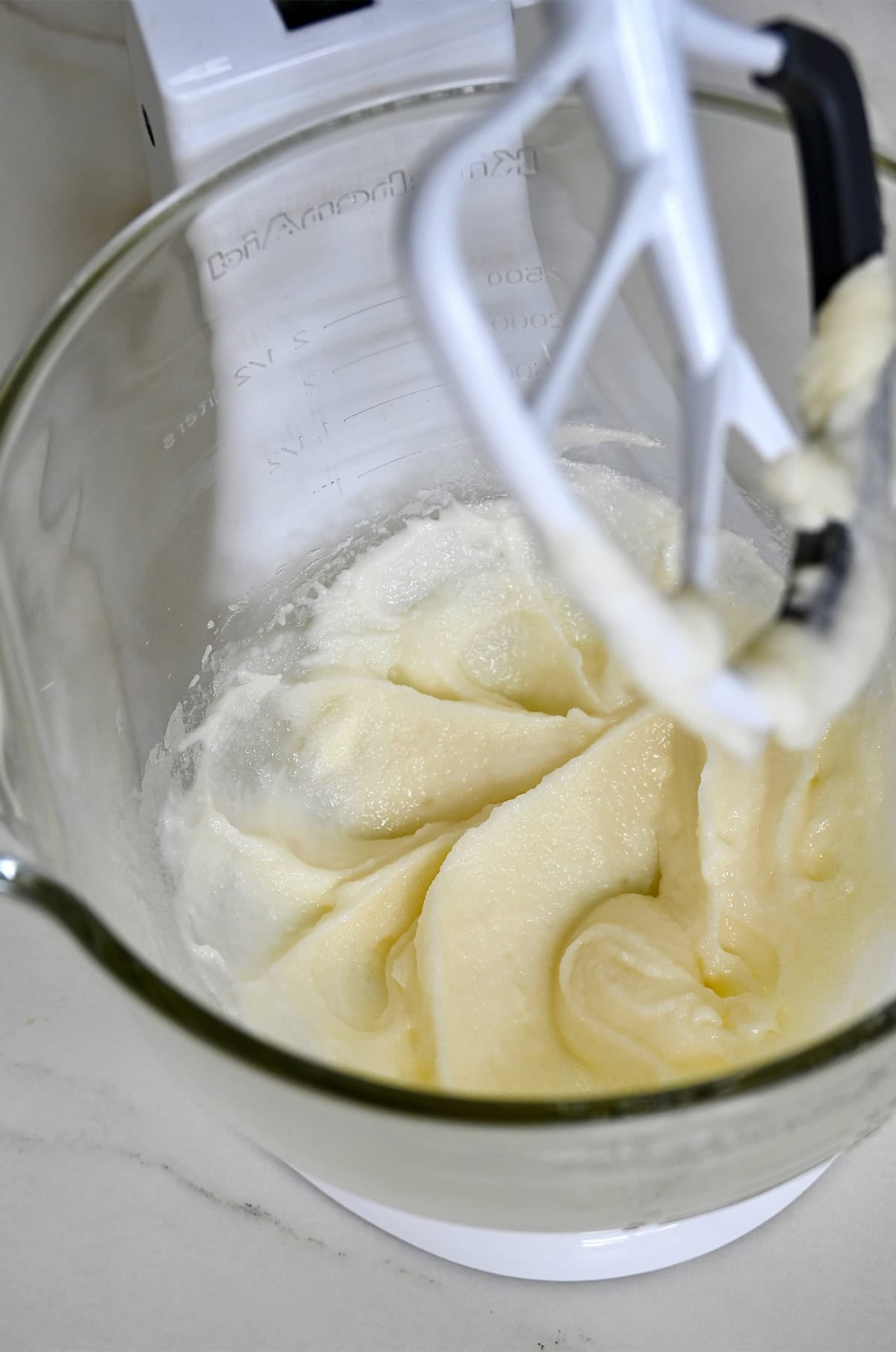 Creamed butter, oil and sugar in a bowl of a stand mixer.
