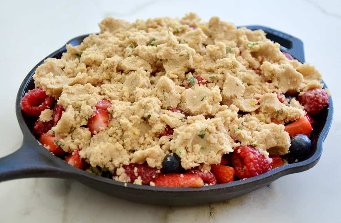 A cast-iron skillet filled with fruit crumble