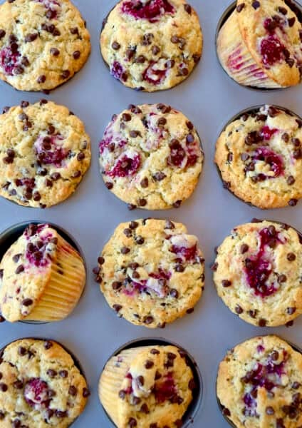 Raspberry muffins with mini chocolate chips in a muffin pan.