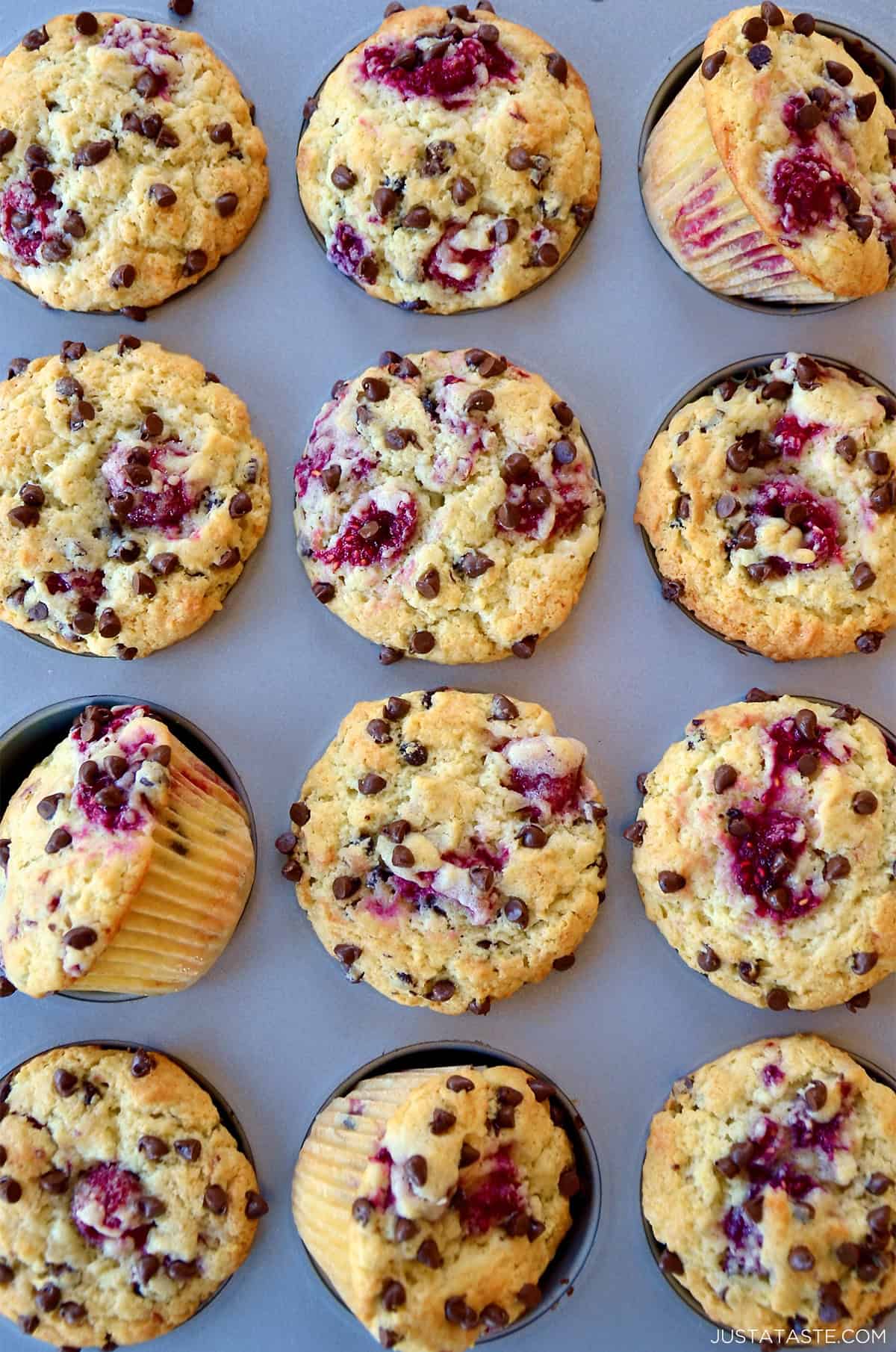 Raspberry muffins with mini chocolate chips in a muffin pan.