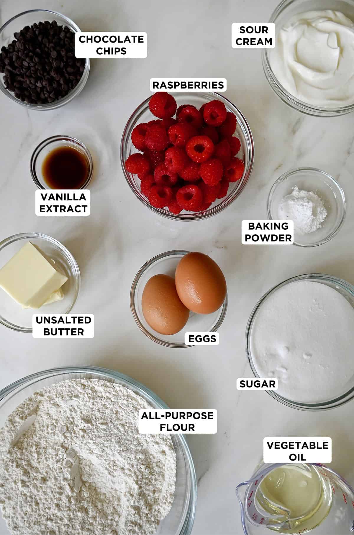 Ingredients to make raspberry muffins with chocolate chips.