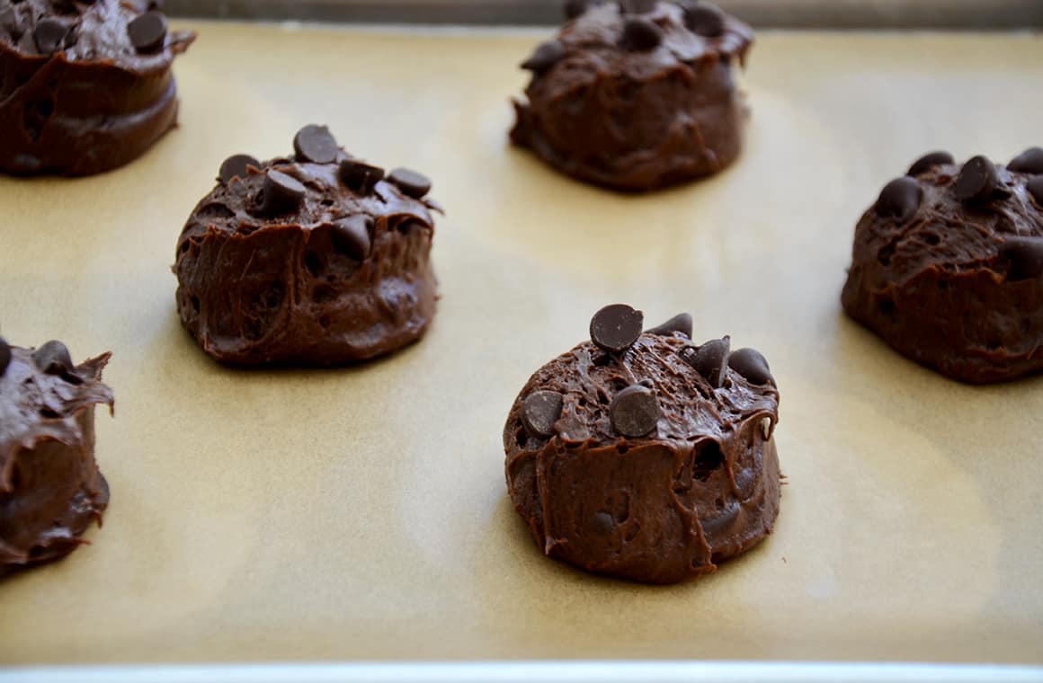 Scooped out brownie cookies on a baking sheet