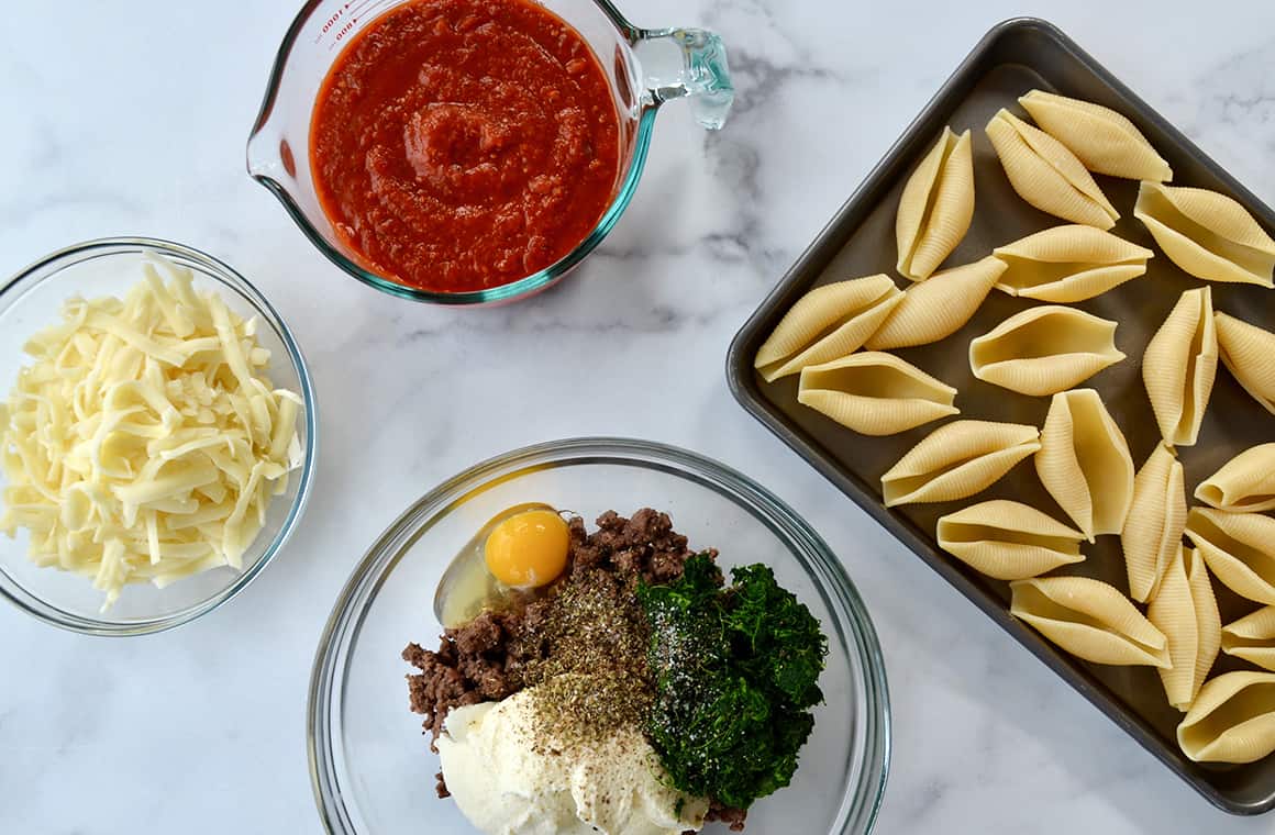 Ingredients for stuffed shells in glass bowls