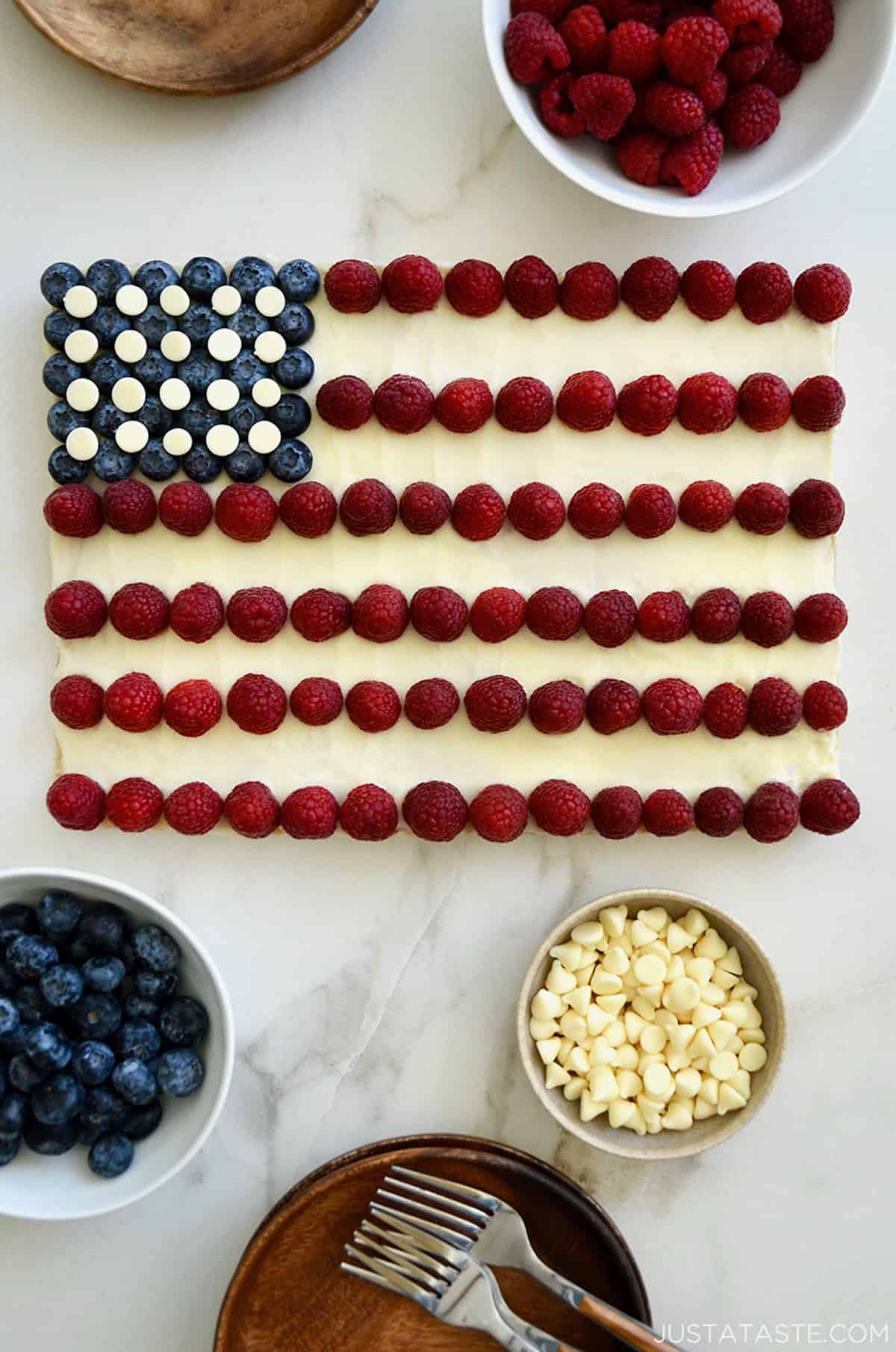 American flag cookie cake with cream cheese frosting, blueberries, raspberries and white chocolate chip stars.