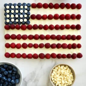 An American Flag Cookie Cake surrounded by bowls of berries