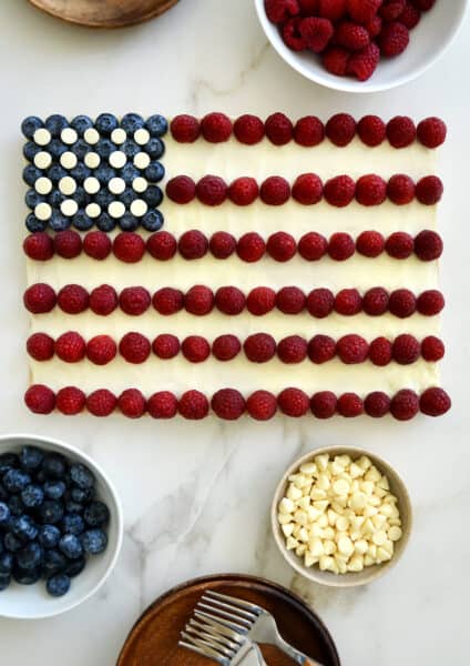 An American Flag Cookie Cake surrounded by bowls of berries