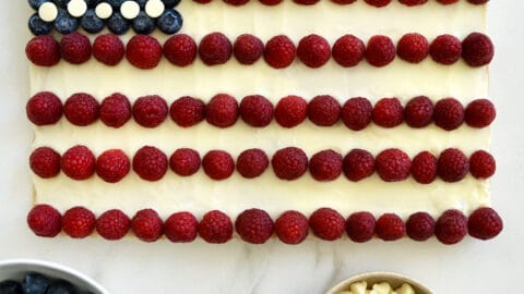 An American Flag Cookie Cake surrounded by bowls of berries