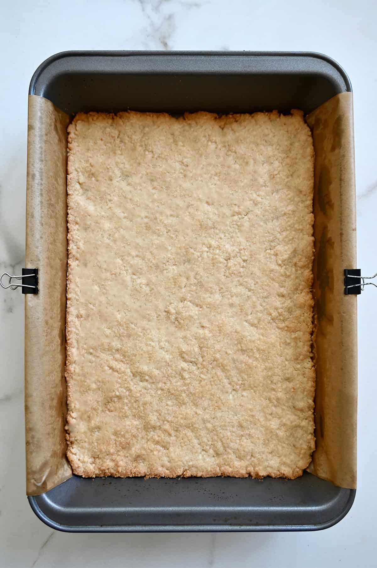 Pale golden baked shortbread cookie cake.