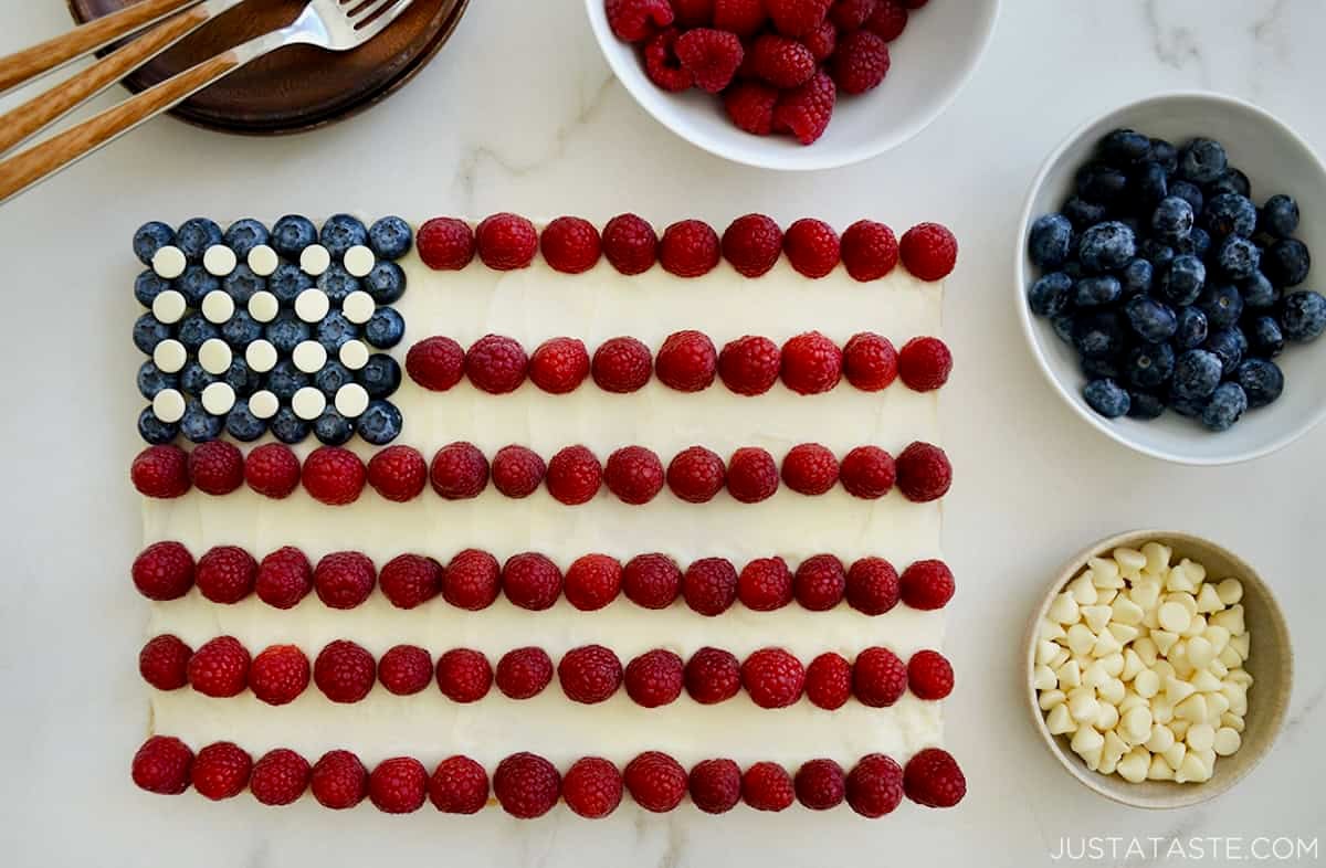 A cookie cake shaped like an American flag with berries.