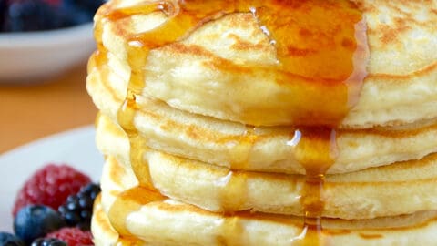 A stack of Greek Yogurt Pancakes topped with fruit