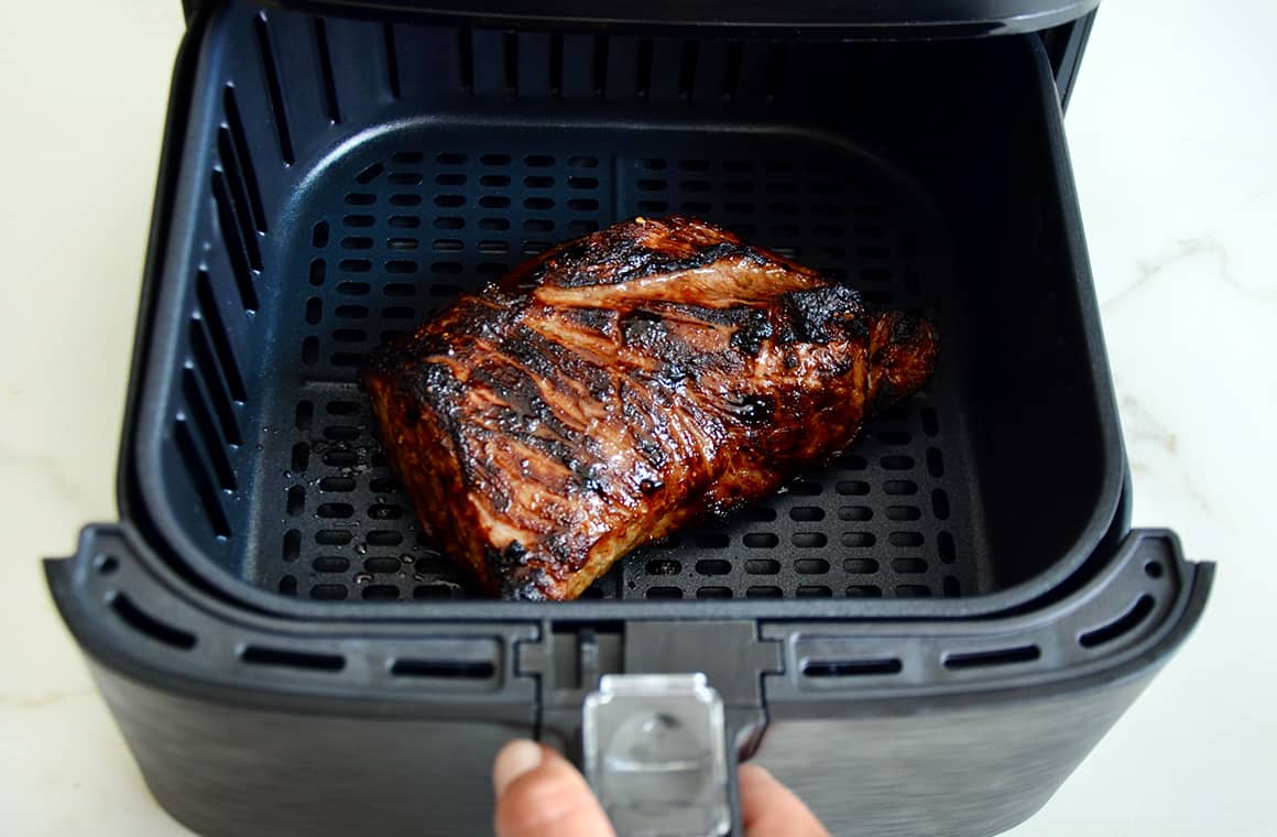 Marinated tri-tip in the basket of an air fryer