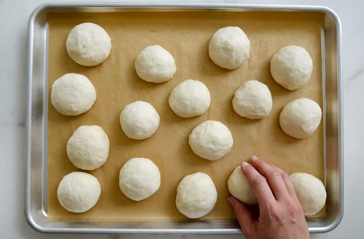 Balls of pretzel dough on a baking sheet
