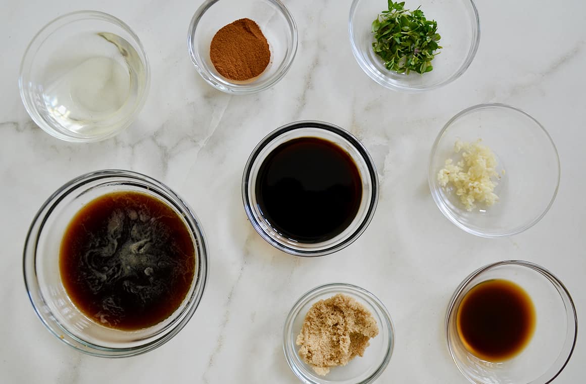 Glass bowls containing ingredients for steak marinade