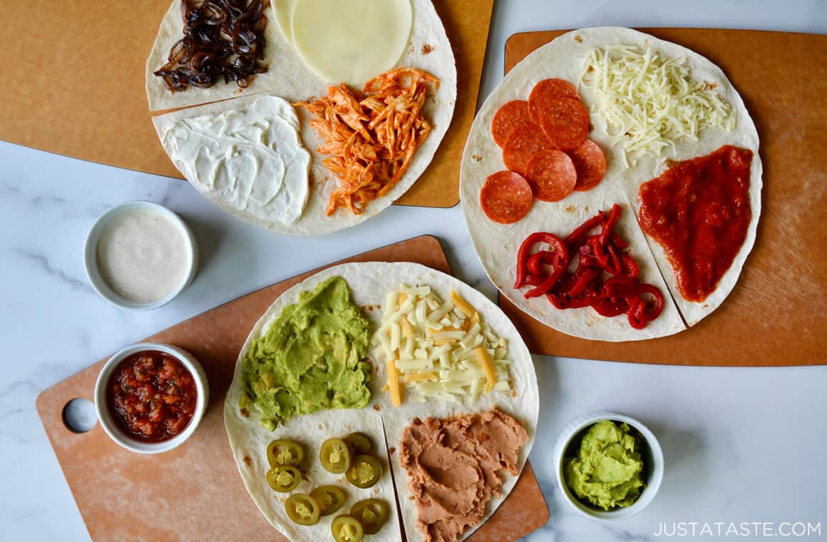 Three flour tortillas topped with various ingredients