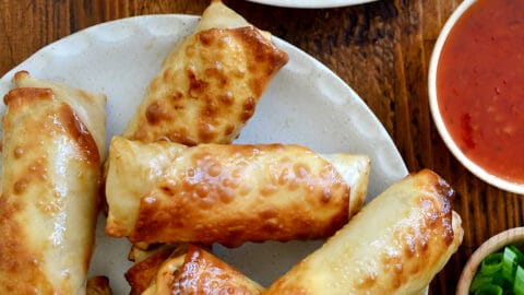 A top-down view of Air Fryer Egg Rolls on a white serving plate