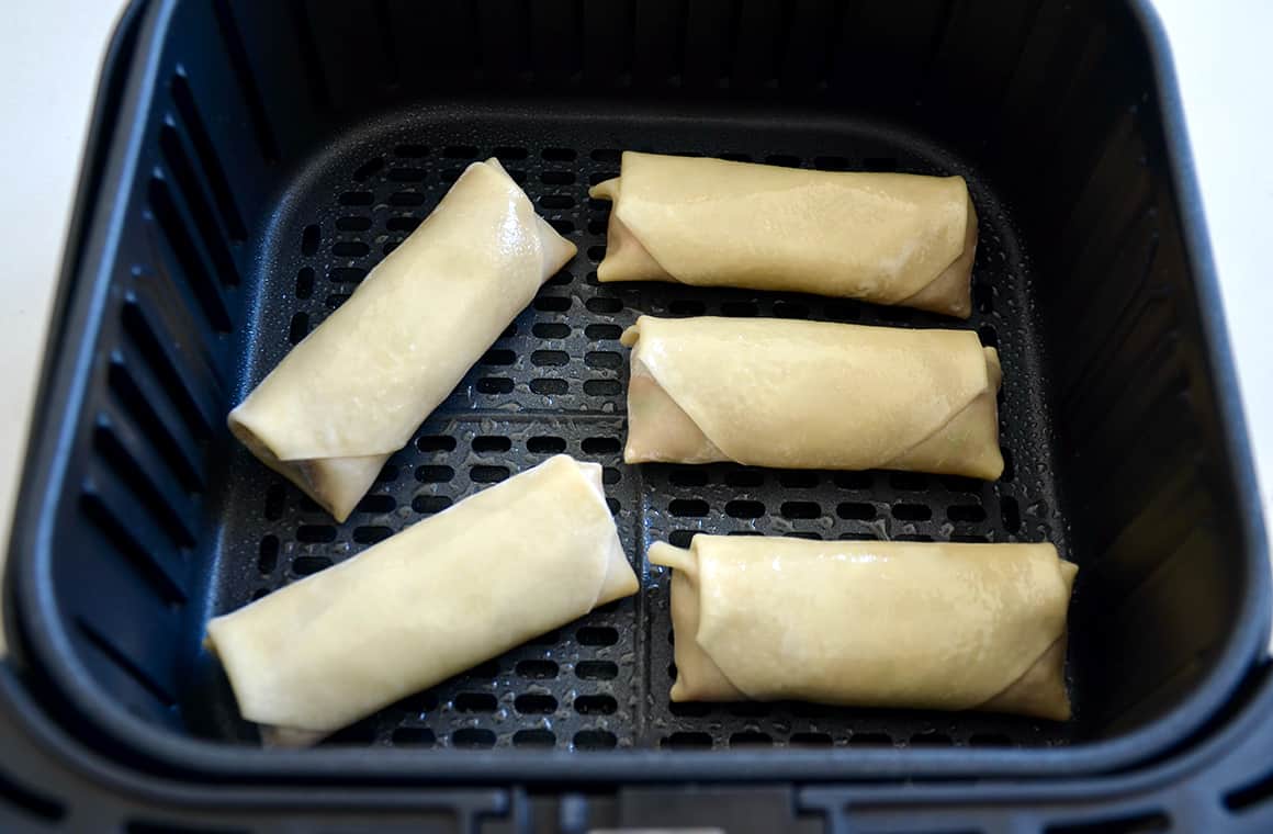 Egg rolls in an air fryer basket