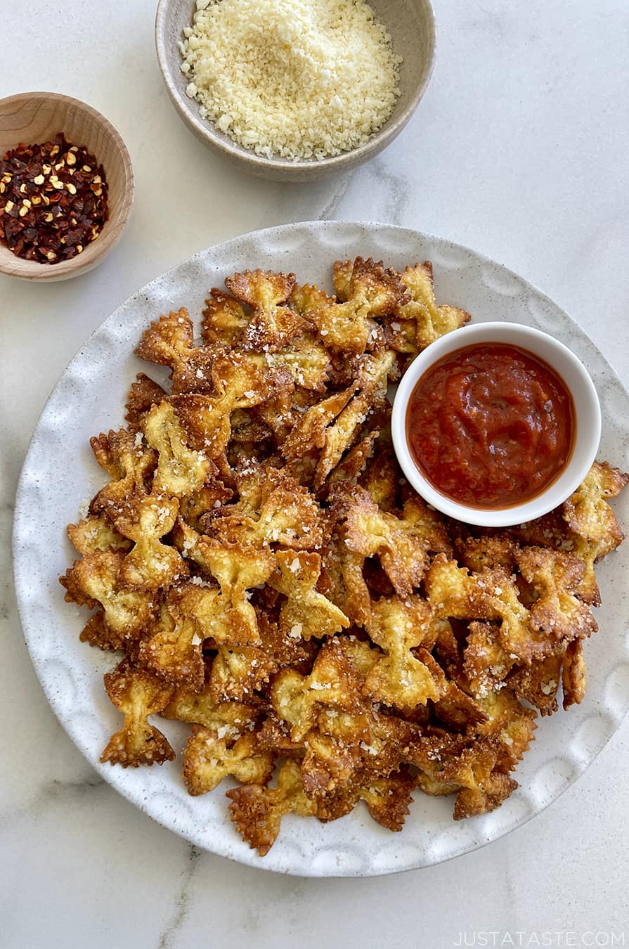 A plate of Parmesan pasta chips served with marinara sauce