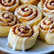 Pizza Dough Cinnamon Rolls with vanilla glaze on a serving plate