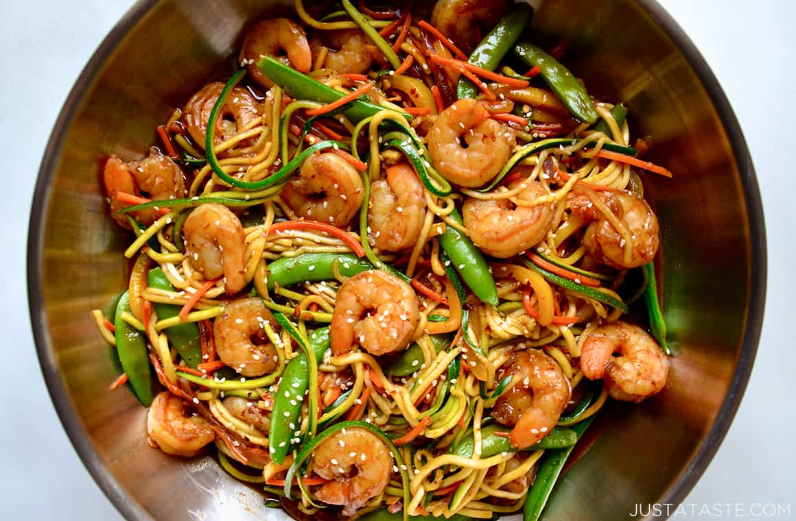 A top-down view of stir-fry with zucchini noodles and shrimp