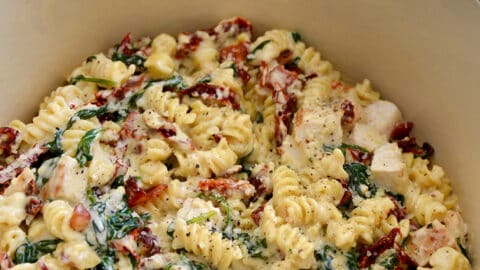A large light blue pot containing Creamy Tuscan Chicken Pasta