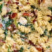 Creamy Tuscan Chicken Pasta starring spinach, cubed chicken breast and sun-dried tomatoes.