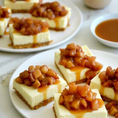 Two plates containing Easy Caramel Apple Cheesecake Bars
