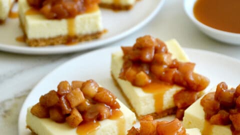 Two plates containing Easy Caramel Apple Cheesecake Bars