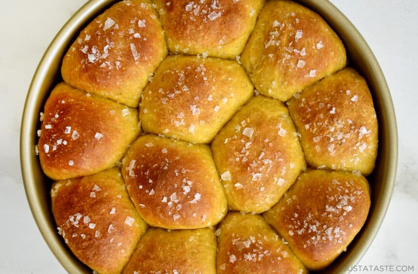 A top down view of baked dinner rolls topped with sea salt