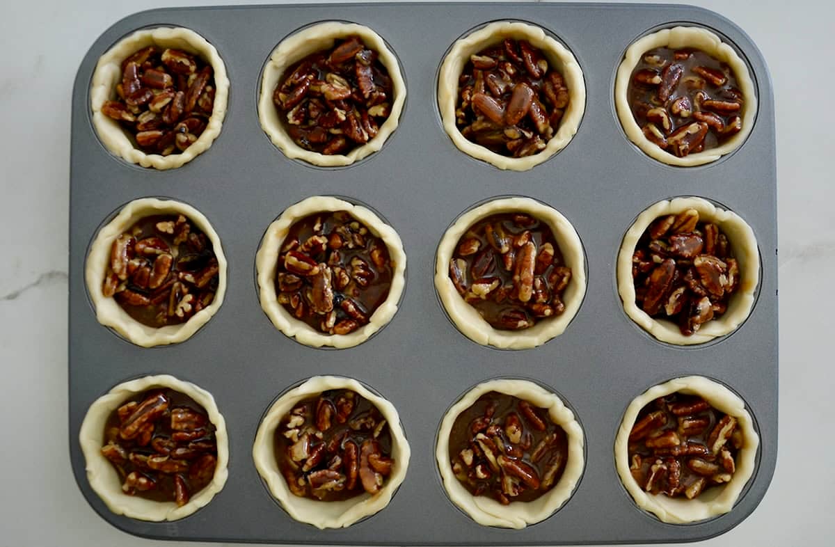Unbaked mini pies in a standard 12-cup muffin pan.