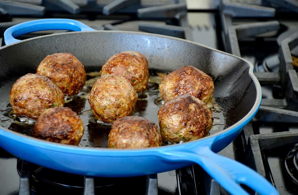 Browning meatballs in a skillet