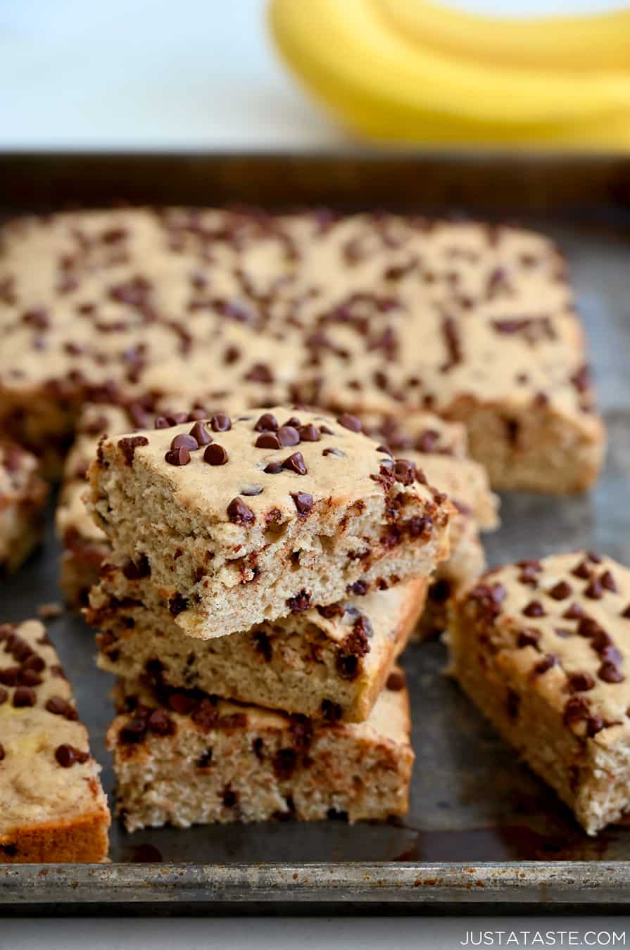 A stack of chocolate chip banana bars on a baking sheet