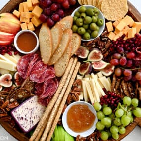 A charcuterie spread with meats, cheeses, olives, fruit and crackers