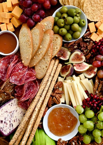 A charcuterie spread with meats, cheeses, olives, fruit and crackers