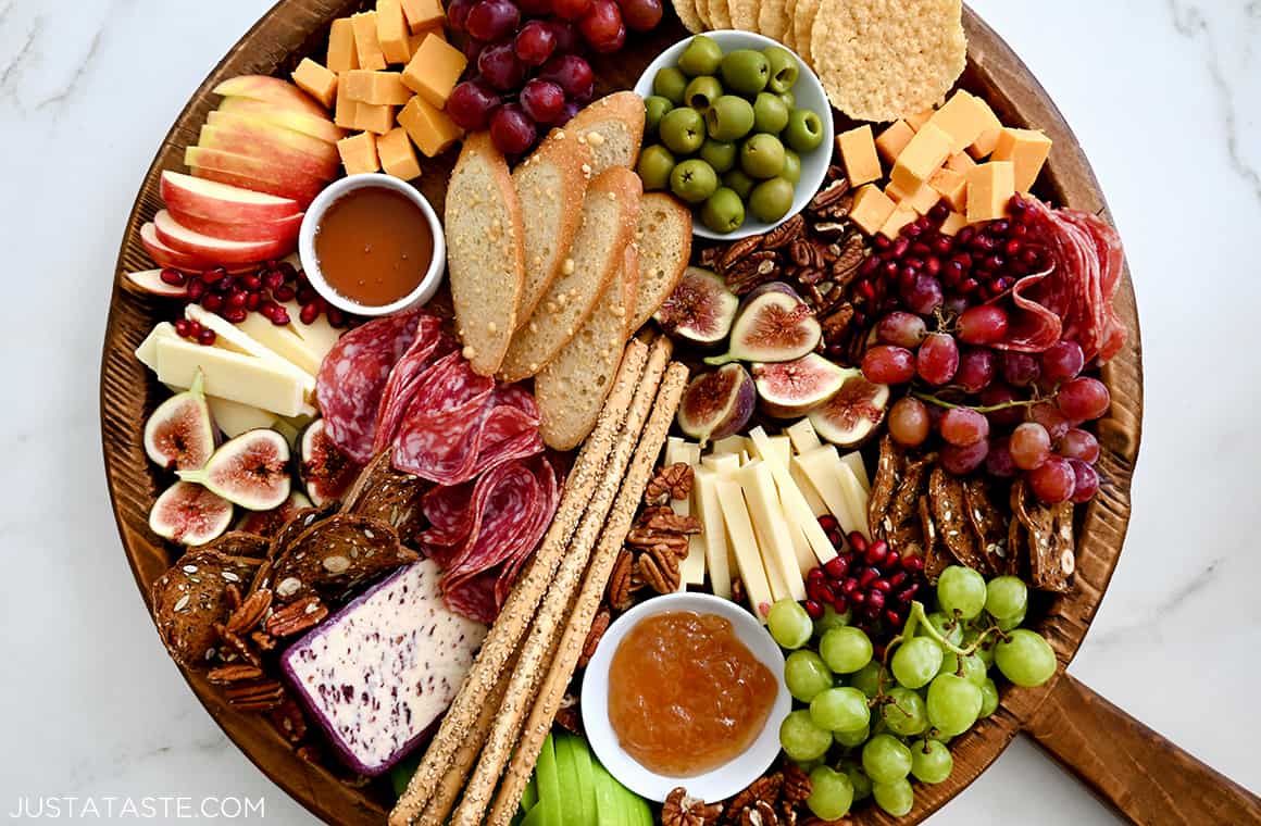 A charcuterie spread with meats, cheeses, olives, fruit and crackers