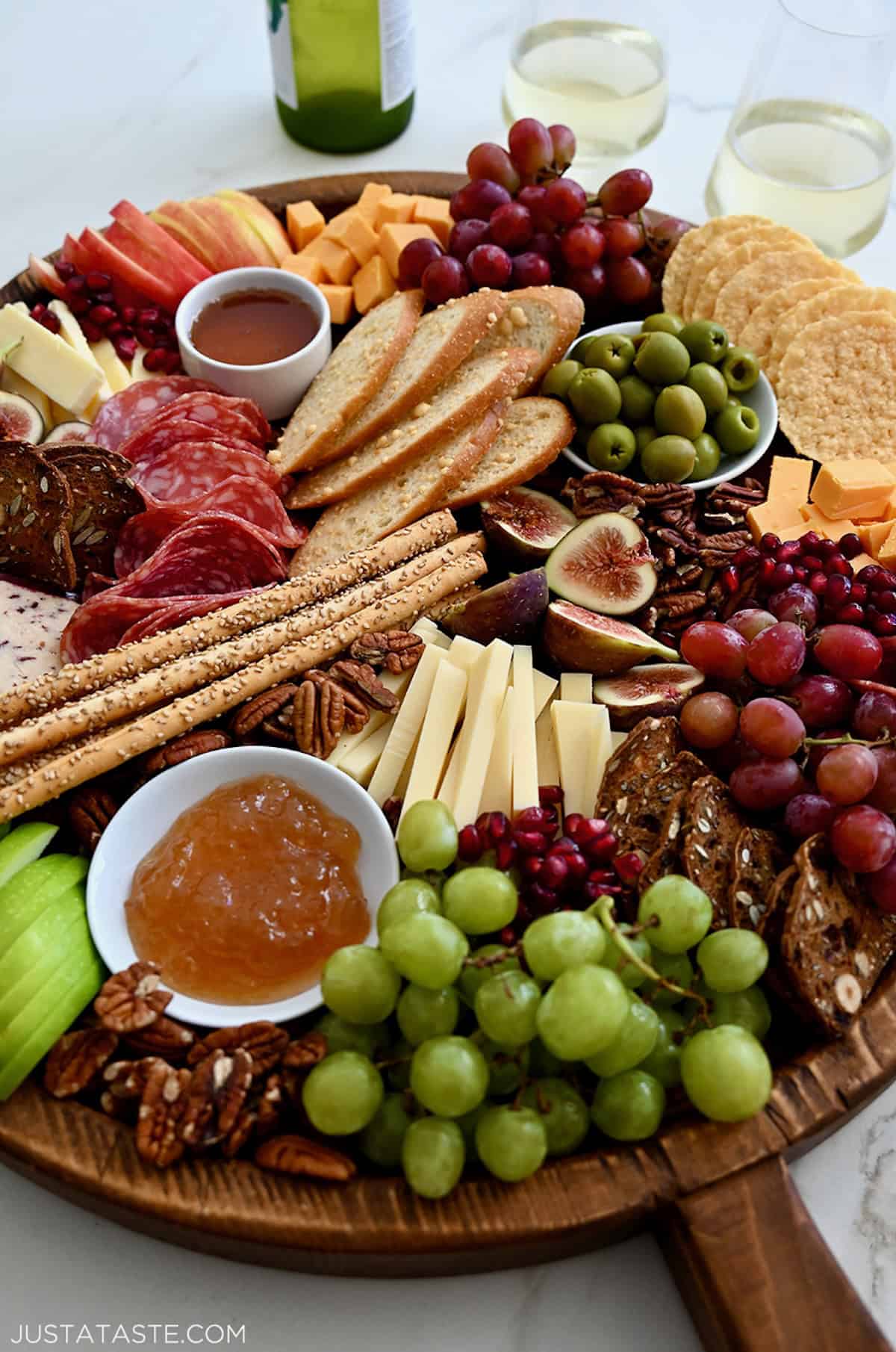 Fall-inspired meat and cheese board with figs, olives, meats, cheeses, fruit and jams.