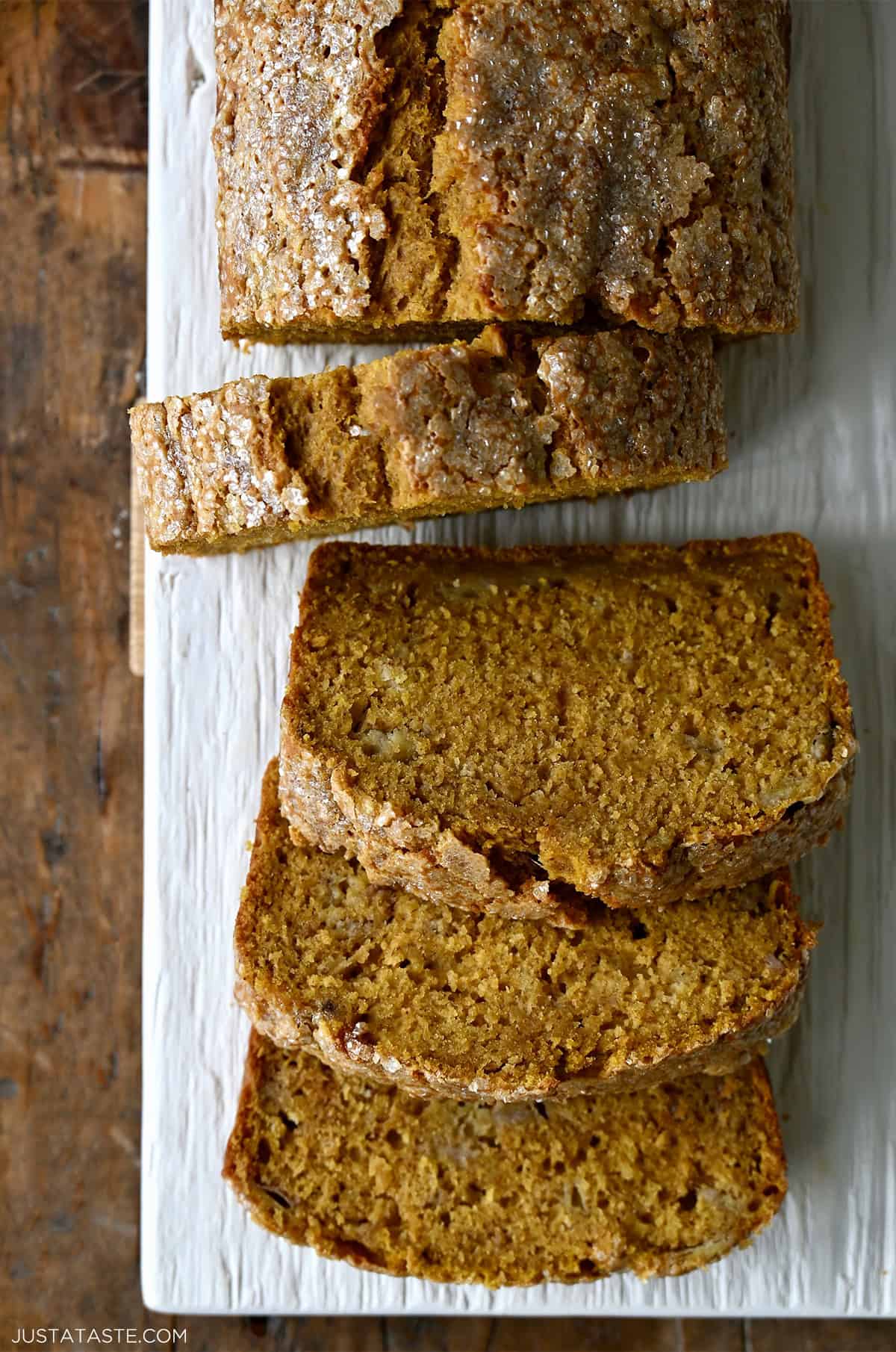 A loaf of pumpkin banana bread cut into thick slices.