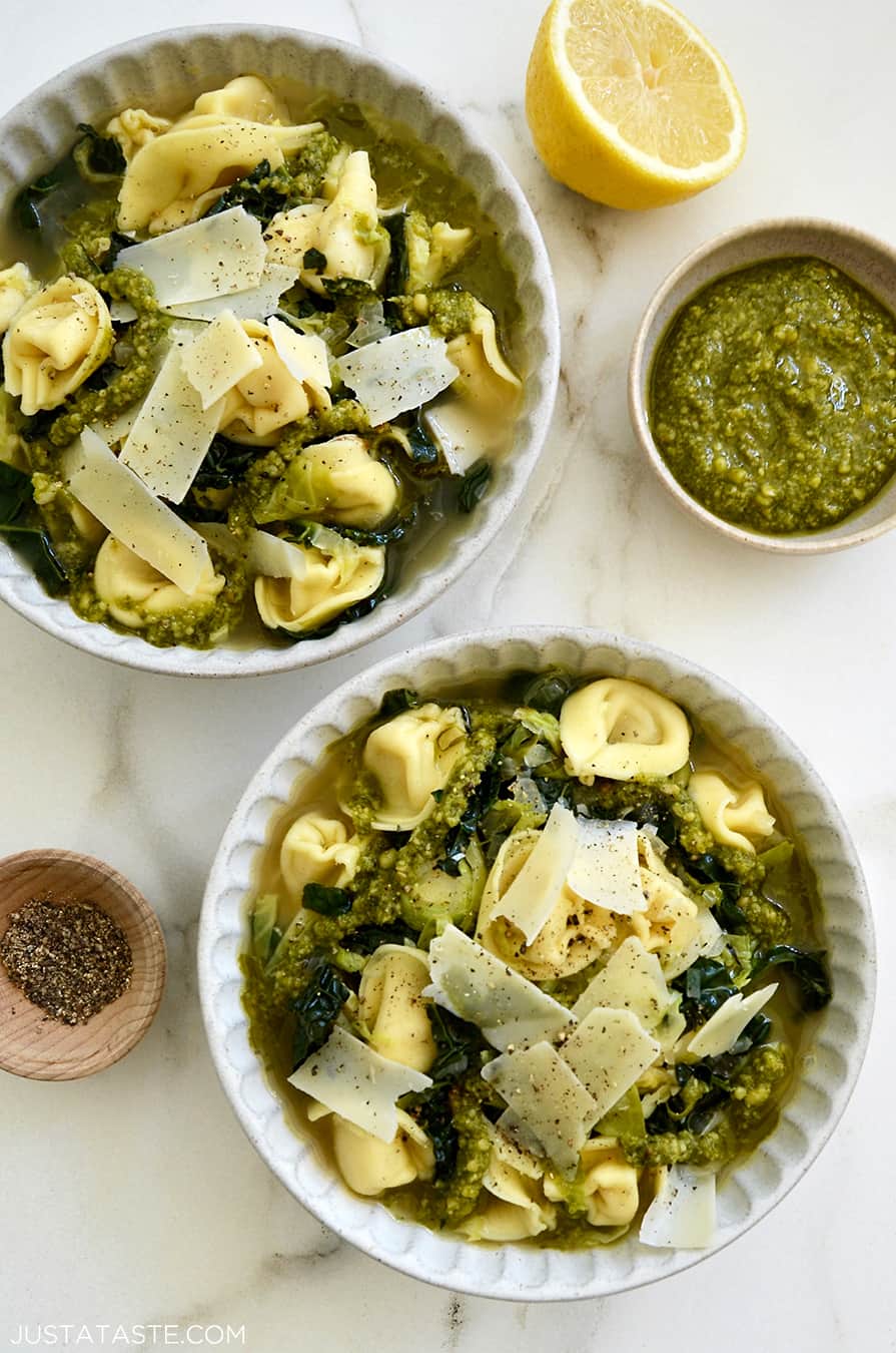 Two bowls containing Quick Tortellini Soup with Greens topped with pesto