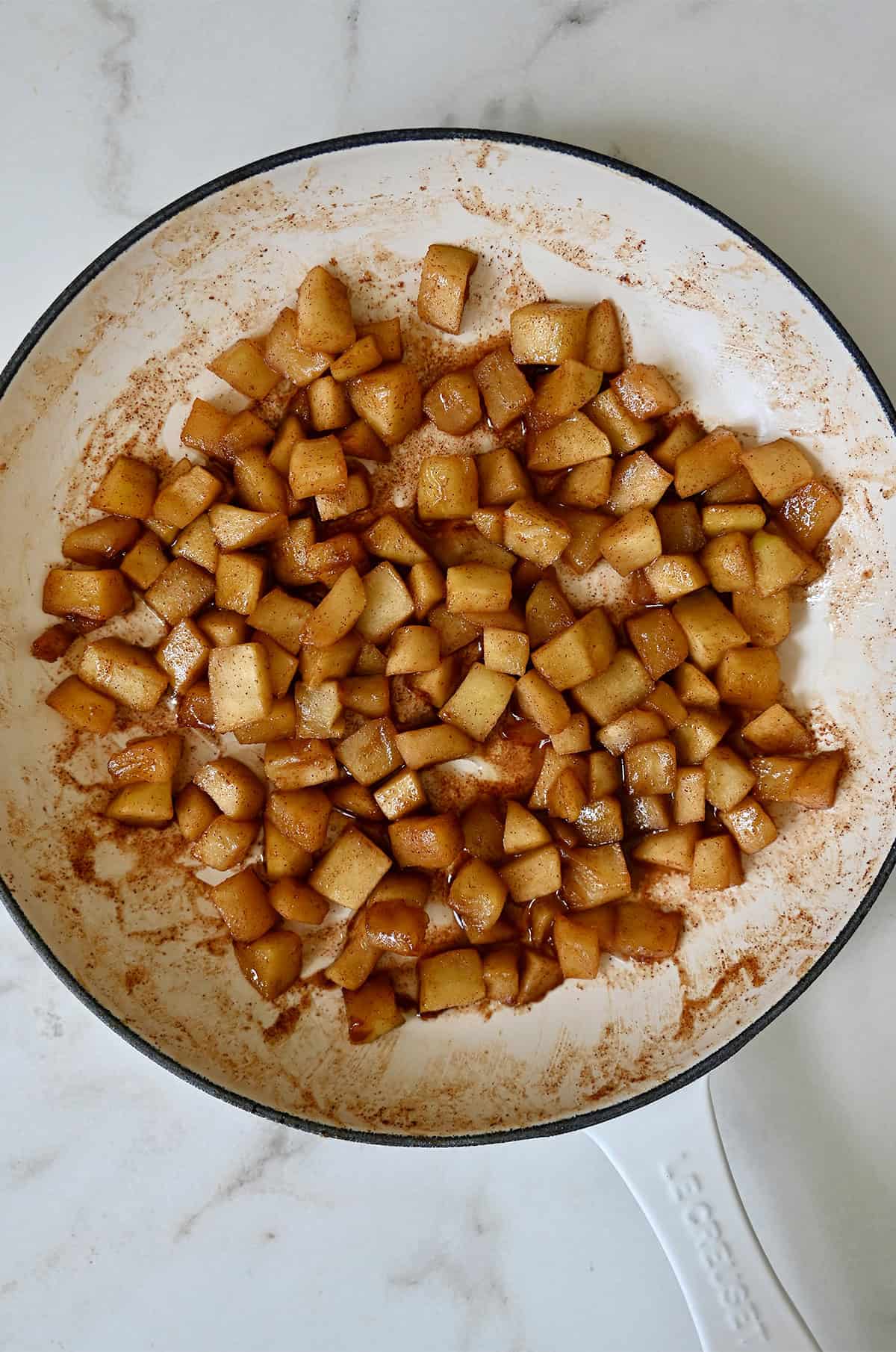 Sautéed brown sugar apple topping in a pan.