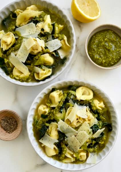 Tortellini soup with kale and Brussels sprouts in a Parmesan-infused broth drizzled with pesto.