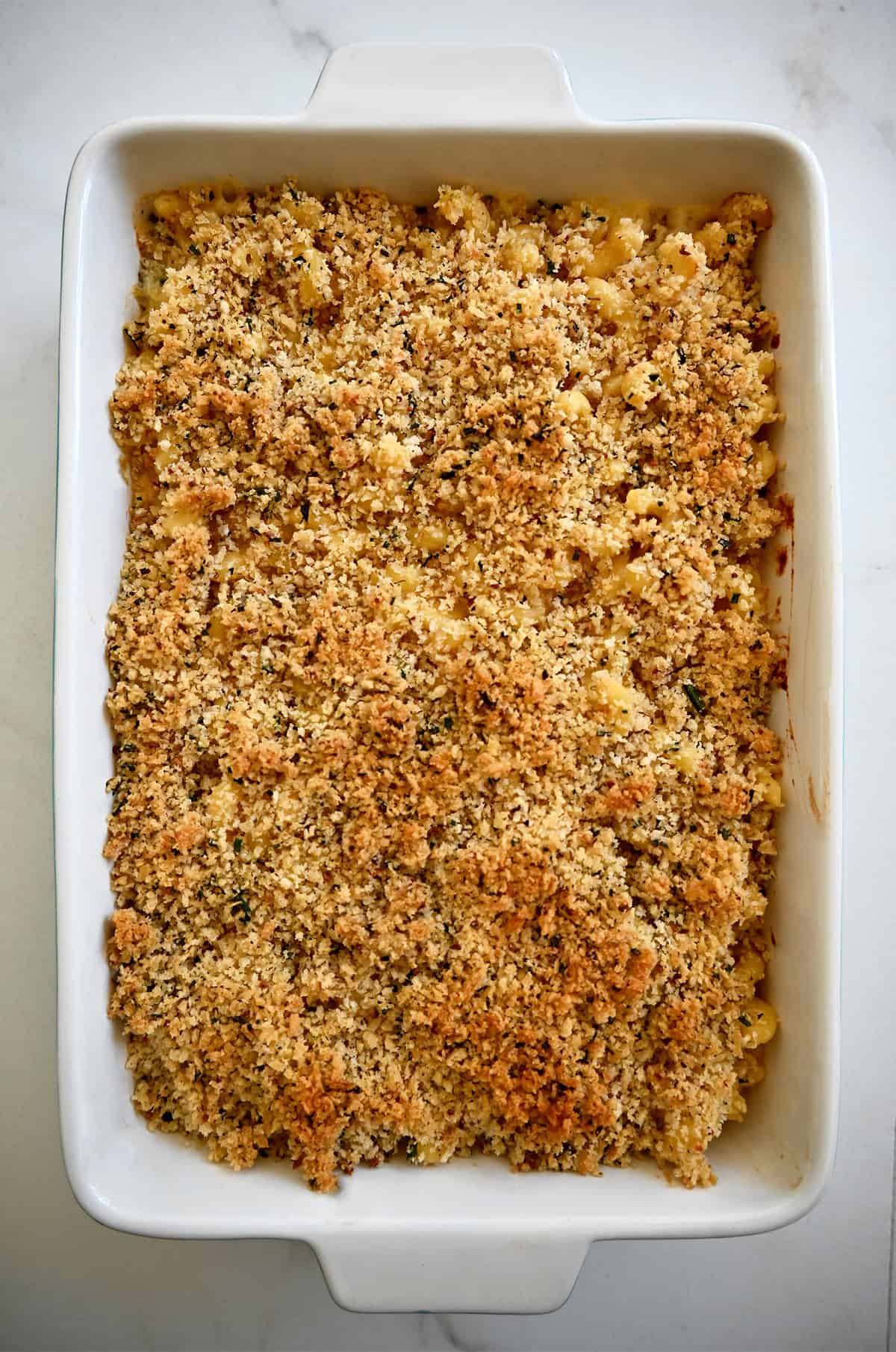 Homemade baked macaroni with a toasted breadcrumb topping in a casserole dish.