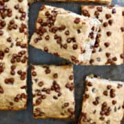 A top-down view of banana bars studded with mini chocolate chips cut into squares.