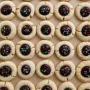 A top-down view of Chocolate Thumbprint Cookies with red, white and green sprinkles.