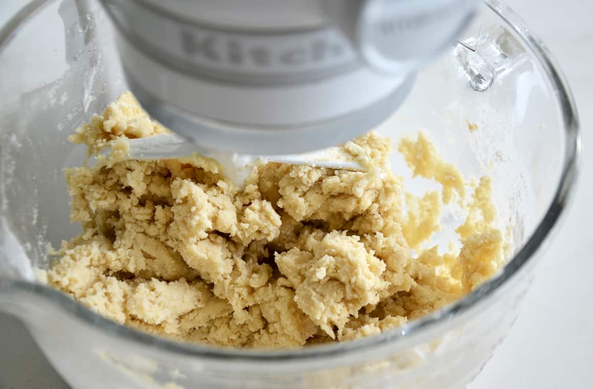 A stand mix bowl with sugar cookie dough