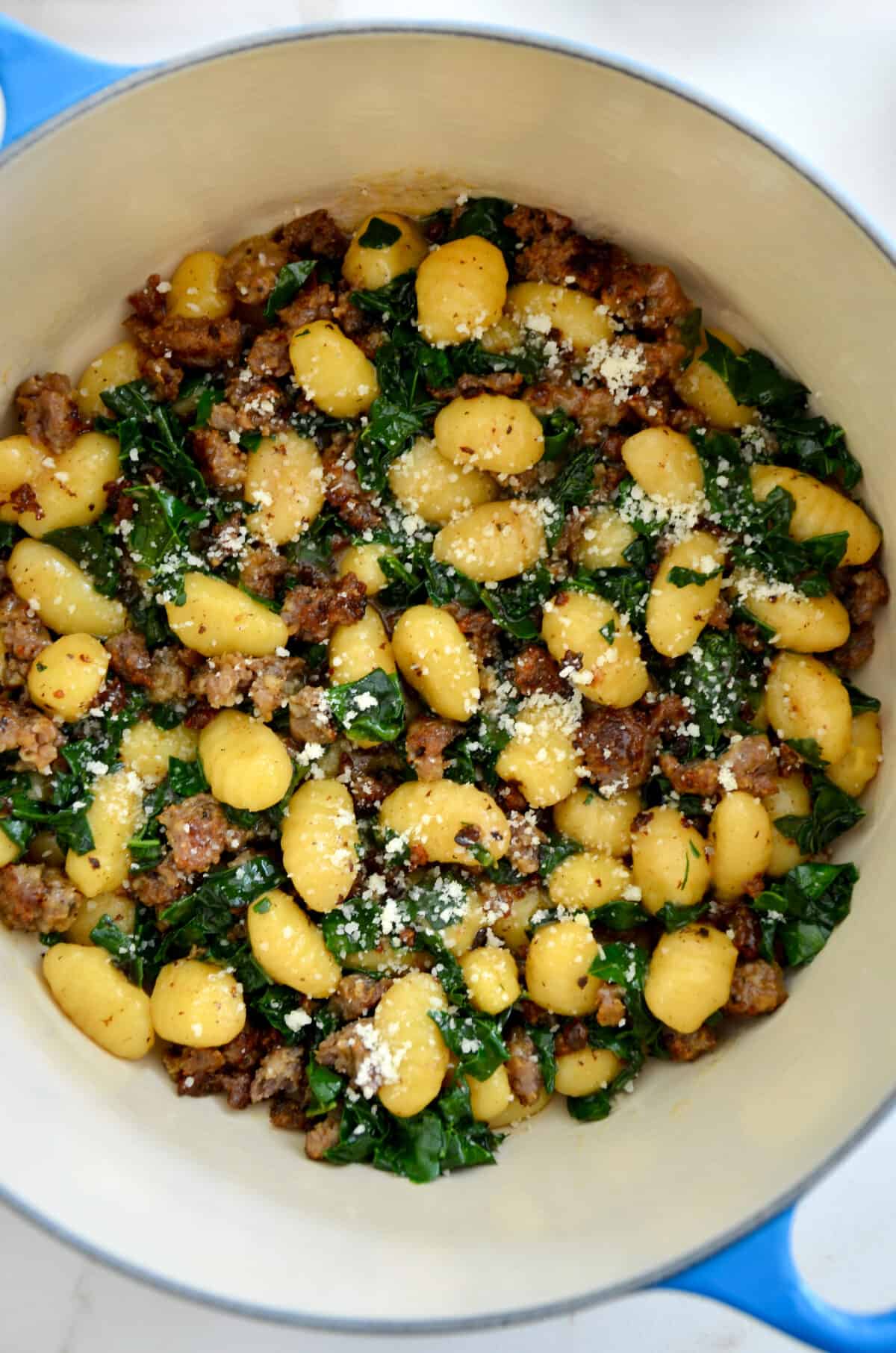 A close-up view of One-Pot Gnocchi with Sausage and kale in a large stock pot